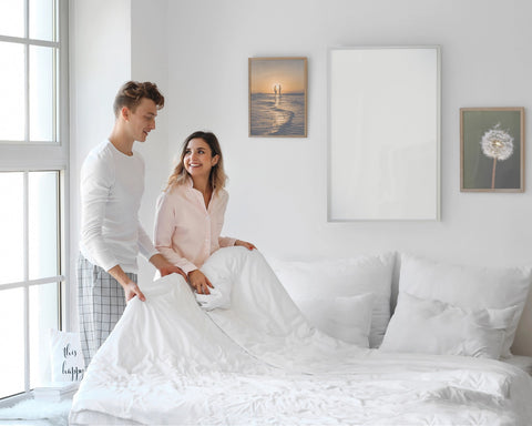 A couple in front of aninfrared heating panels inthe bedroom