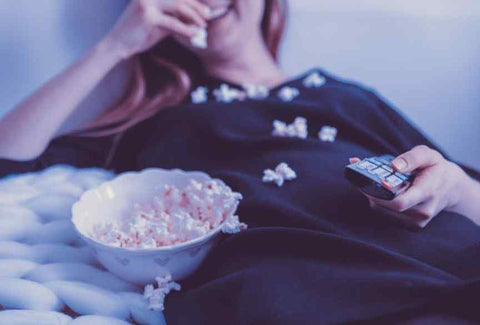 Woman Enjoying Popcorn on the Couch