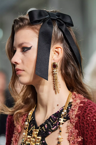 woman having black ribbon on hair 