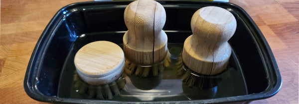 Image of bamboo dish brushes soaking in vinegar