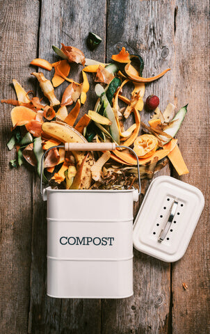 Image of a compost bin laying on it's side with food scrapes spilling out