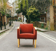 Image of a red chair on the side of the road