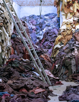 massive pile of textile waste from fast fashion