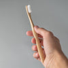 Bamboo toothbrush with ergonomic handle.