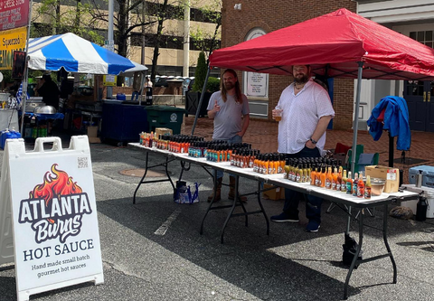 Adam and AJ selling Hot Sauce at Macon Cherry Blossom Festival