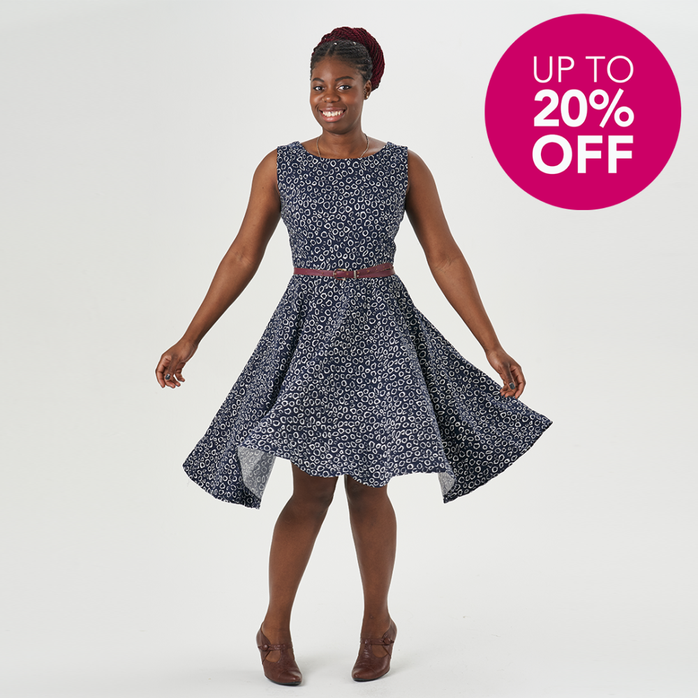 Salma wearing a blue Betty Dress with a pink roundel that says "Up To 20% Off"