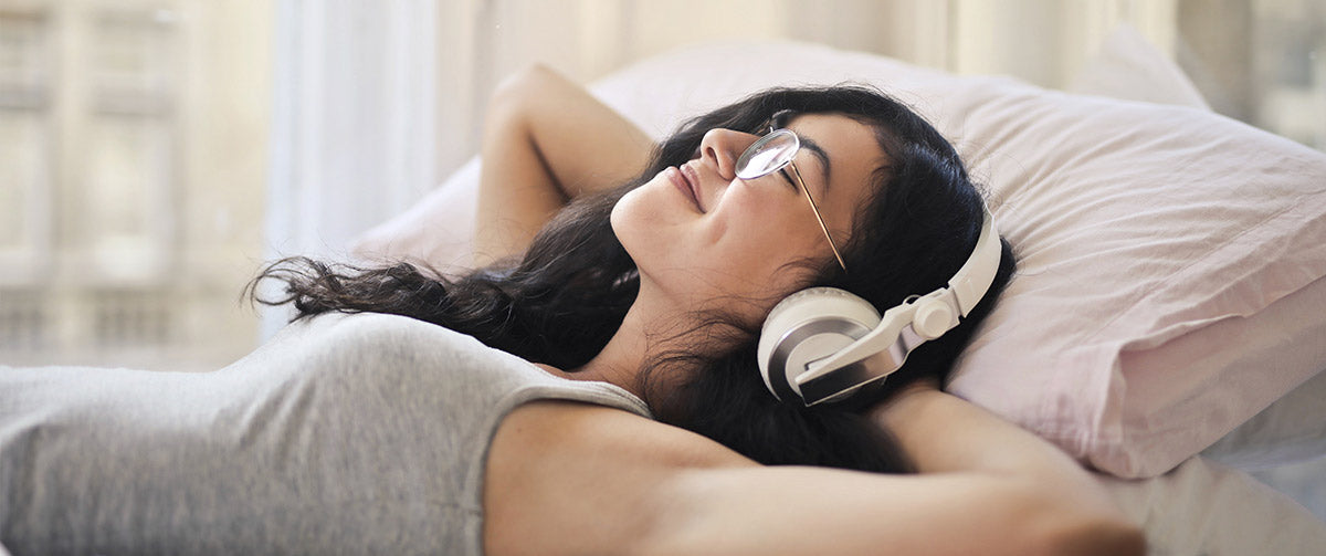 Hypnotherapy on a bed with headphones