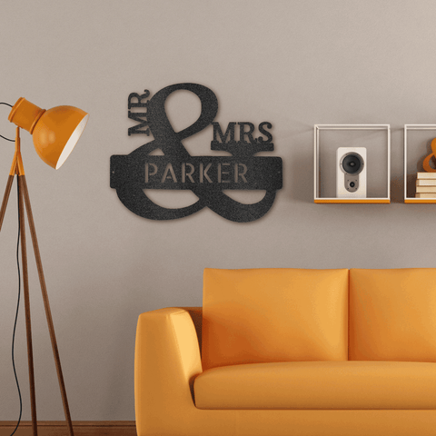 Mr and Mrs monogram hanging on the wall next to an orange couch and lamp