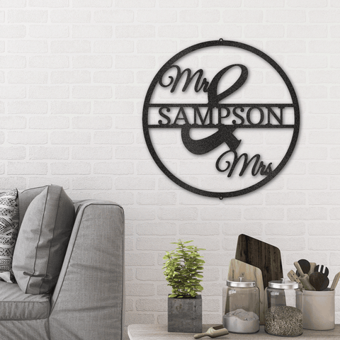 Metal circle monogram with custom last name and mr & mrs hanging on the wall next to a couch