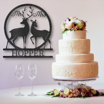 Mr and Mrs Deer metal monogram hanging on the wall next to a wedding cake 