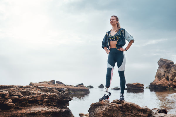 Woman wearing athleisure standing near seaside 