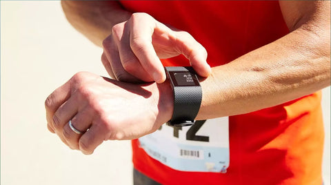 A person checking fitness tracker