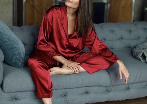a woman sitting in red loungewear