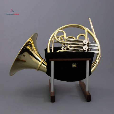 A cloth and wood stand for a French horn