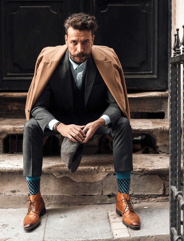 Man wearing statement socks with his dress shoes and suit