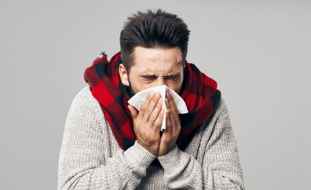 Man uses a handkerchief for a sneeze