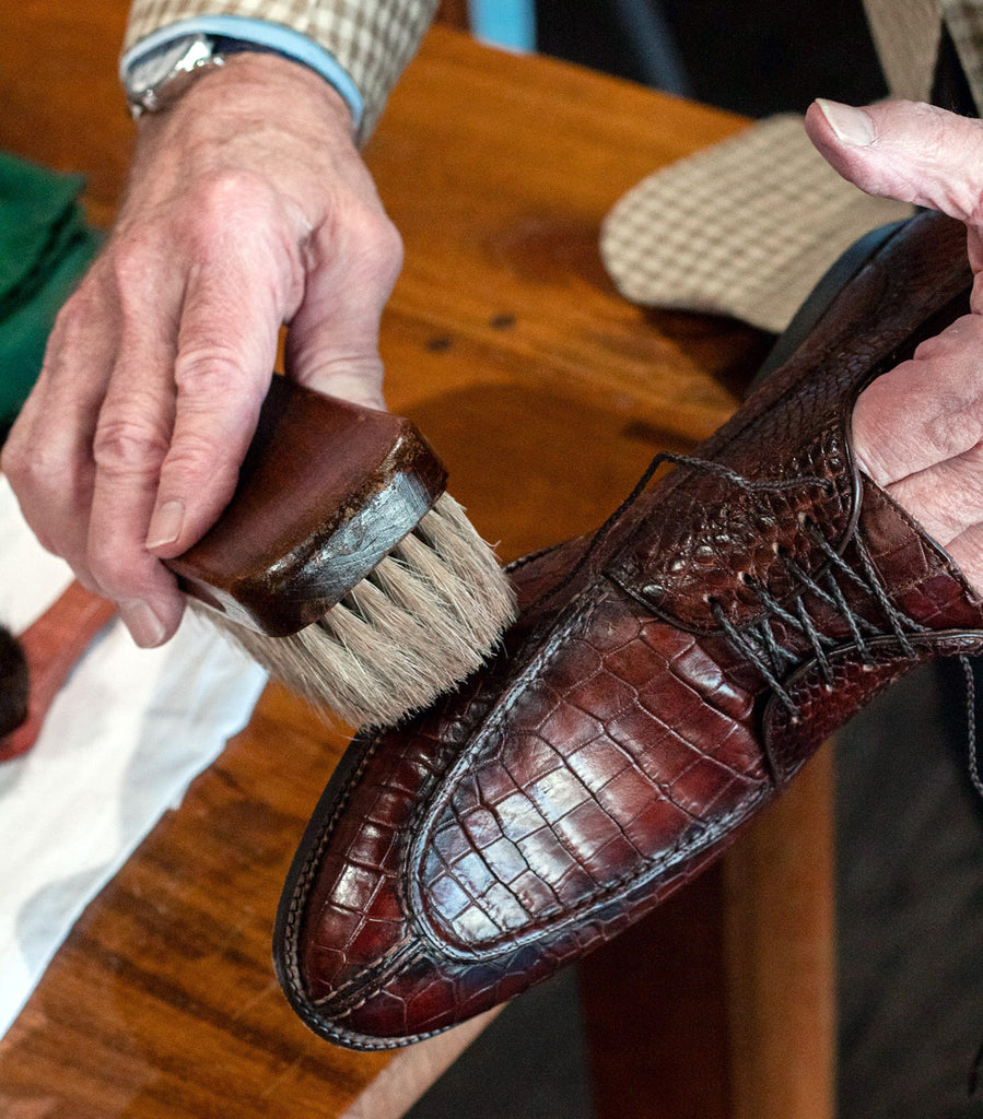 Man buffing and polishing leather shoes