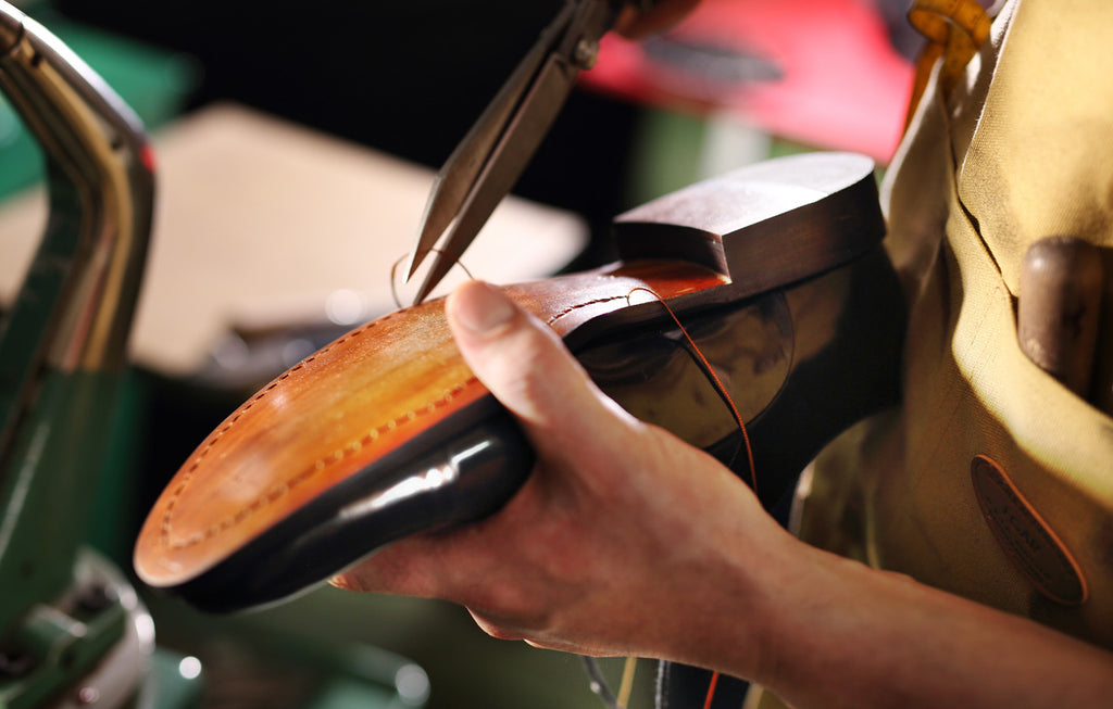 Cobbler doing leather shoe maintenance