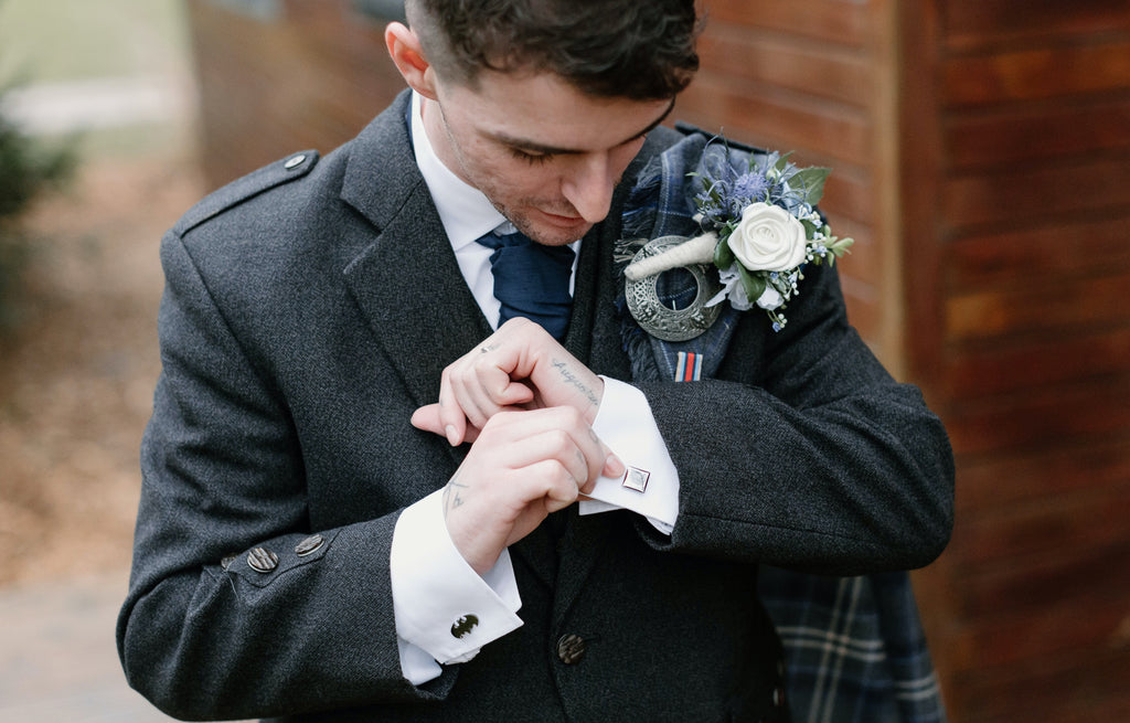 Scottish groom wearing cufflinks for his wedding