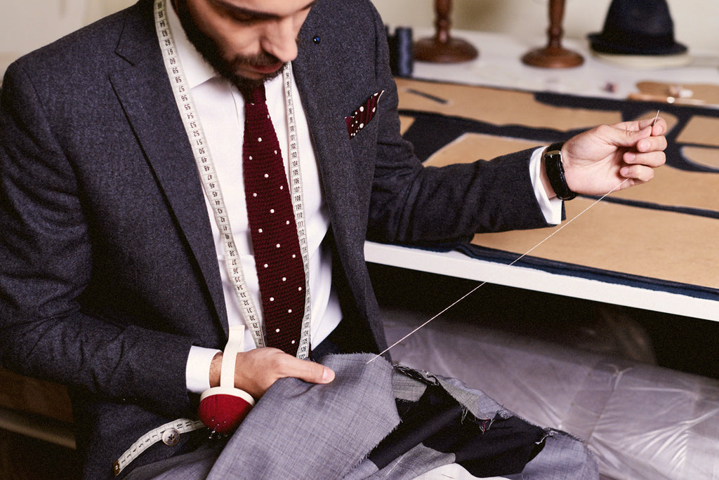 Tailor making a bespoke suit