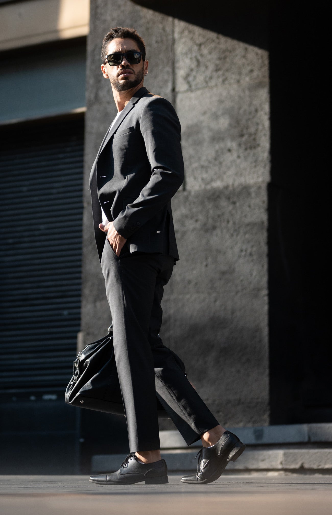 Man wearing a black suit with black shoes