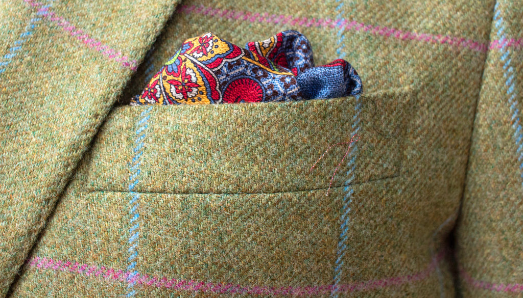 Closeup of tweed material on a jacket, showing its quality