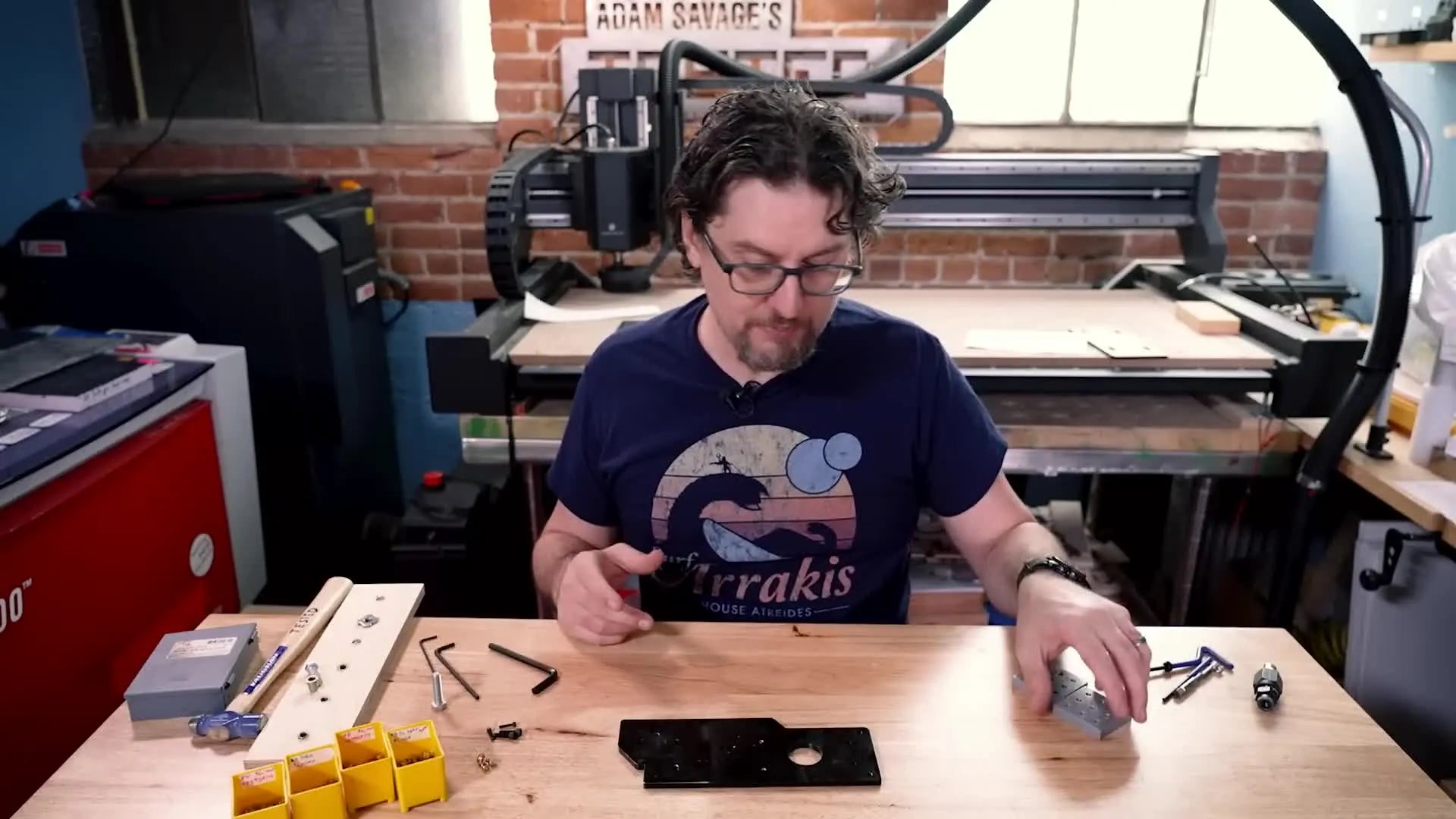 3D printed part with multiple holes and brass press-fit inserts.