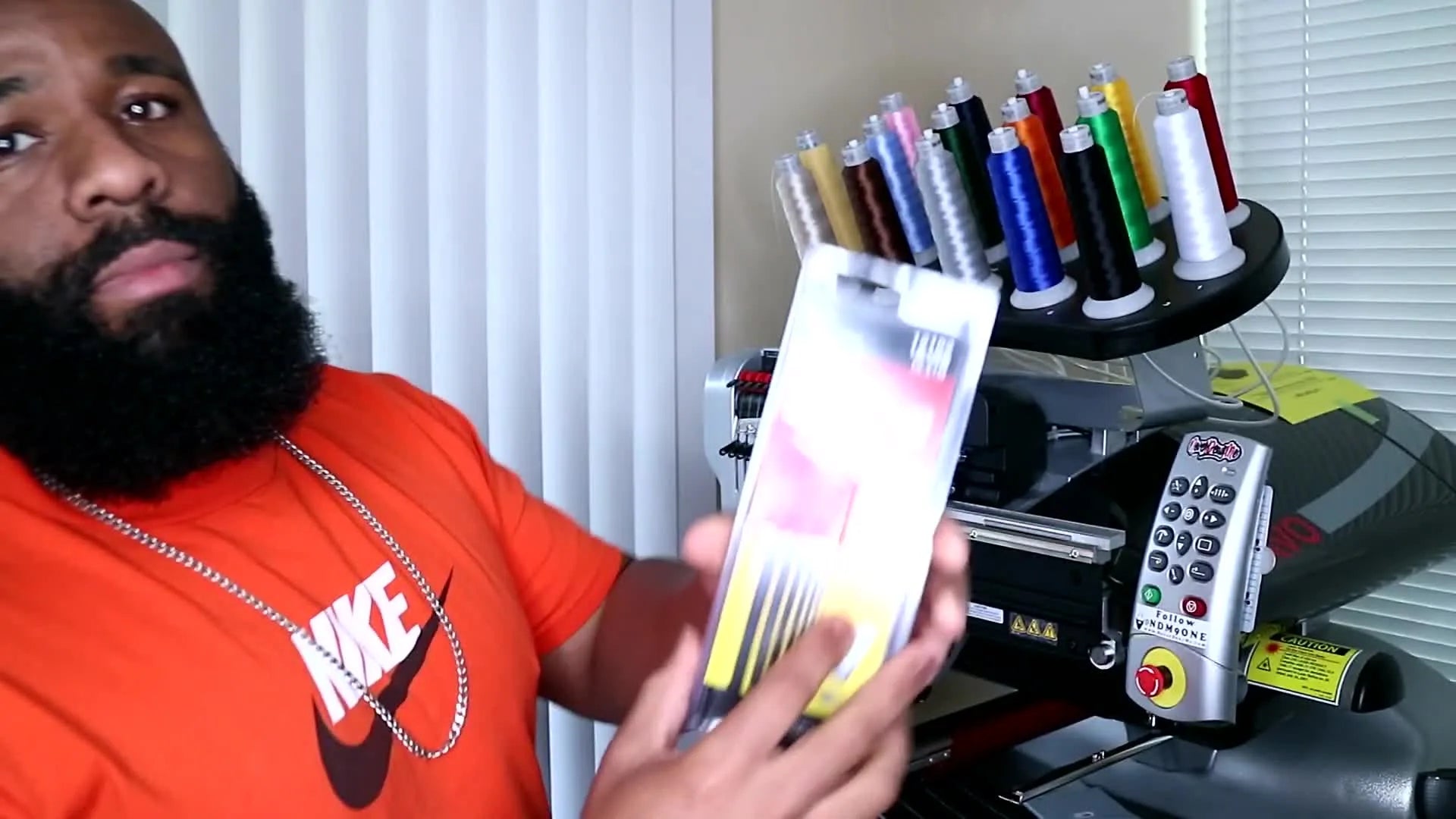 Man holding a 7-piece Allen wrench set.