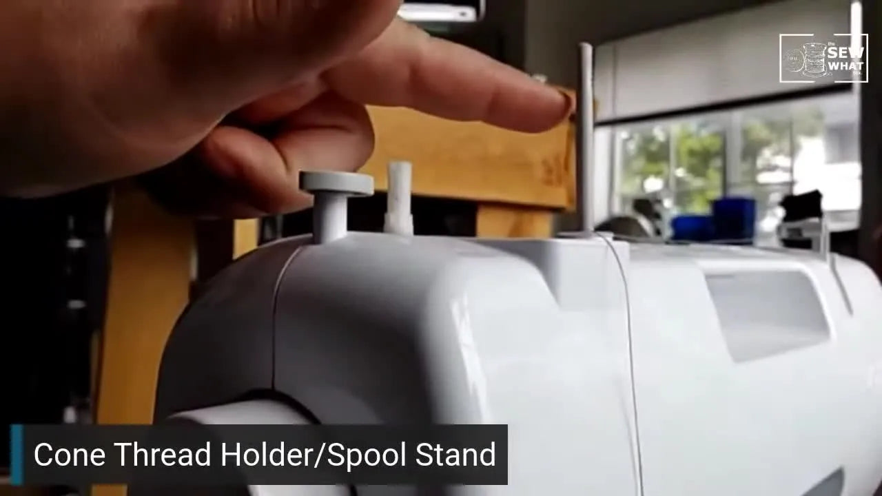 The thread path from the large spool, straight up to the sewing machine's spool pin.