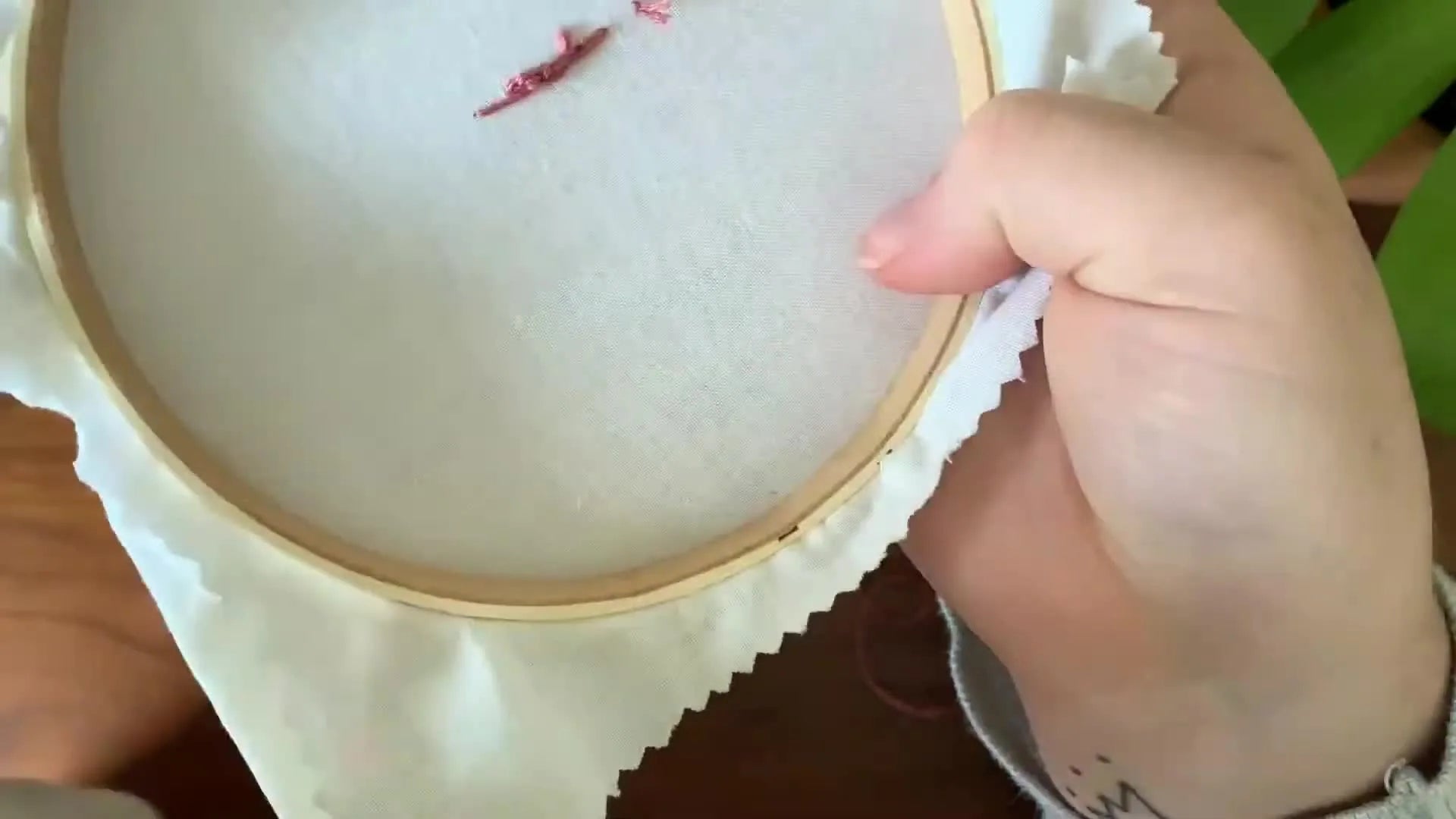 Close-up of the back of the embroidery, showing the finished, secured thread.