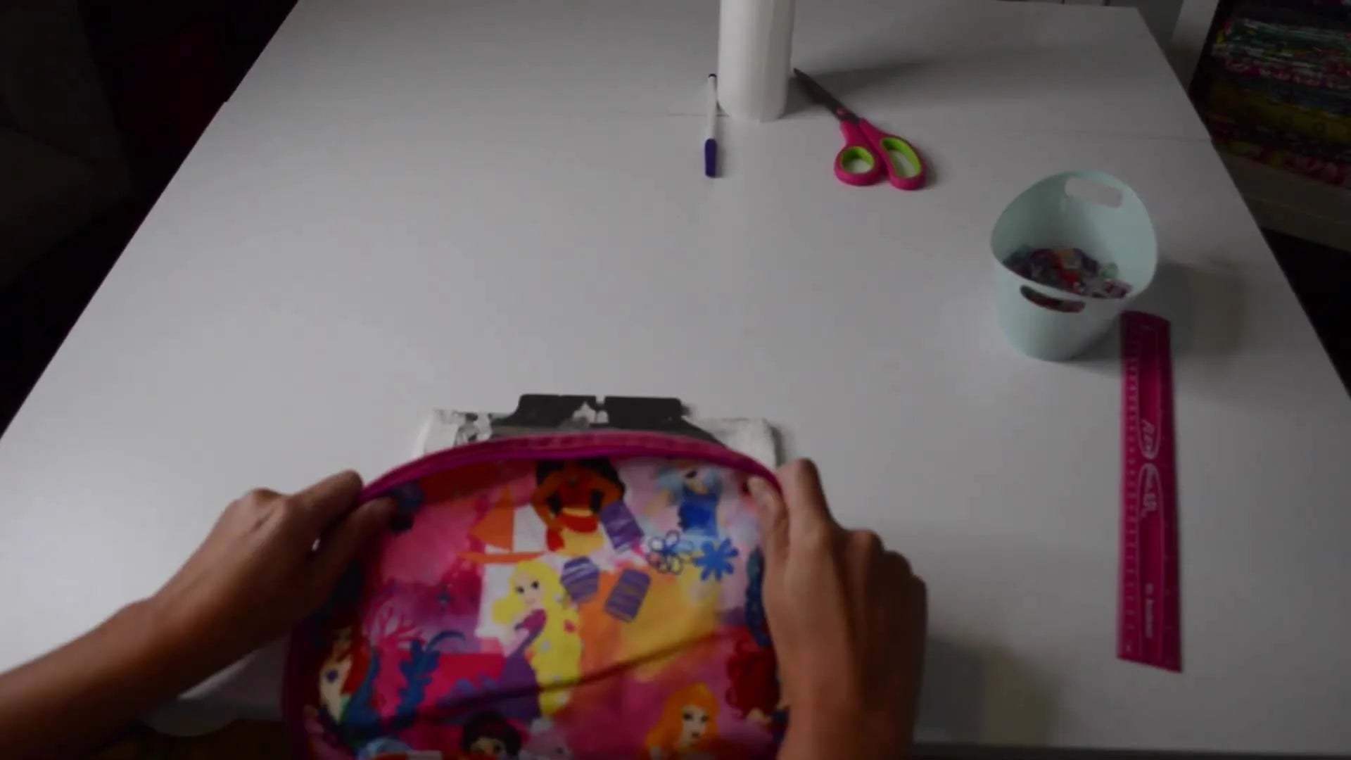 Hands aligning and pressing a backpack onto a sticky stabilizer on a fast frame.