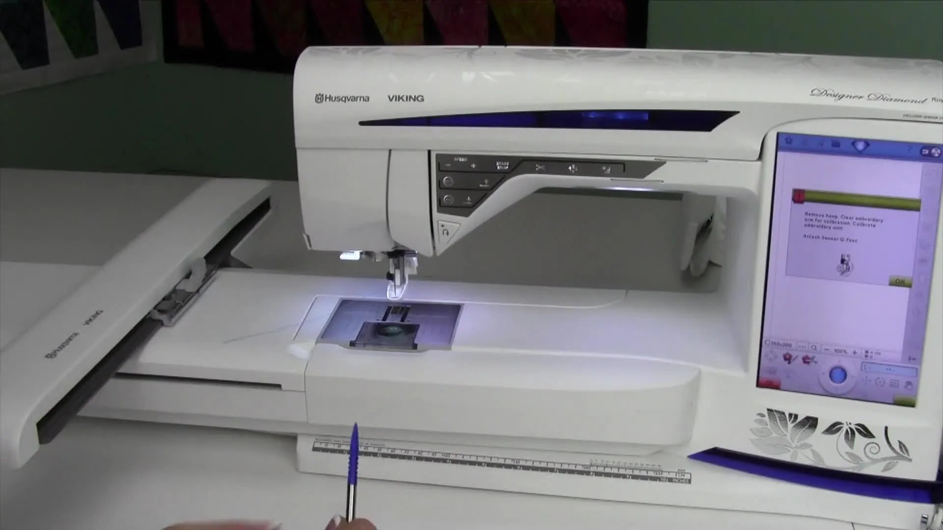 Husqvarna Viking Diamond Royale embroidery machine after being turned on, with the screen lit up.