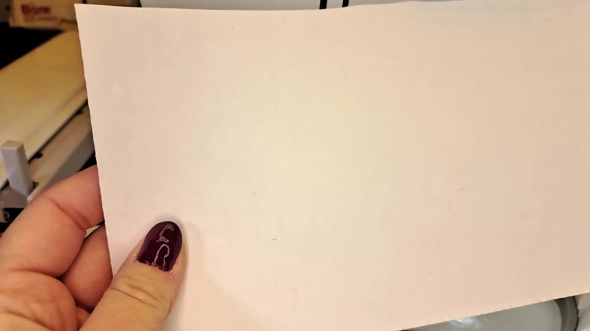 Hands peeling backing off self-adhesive stabilizer.