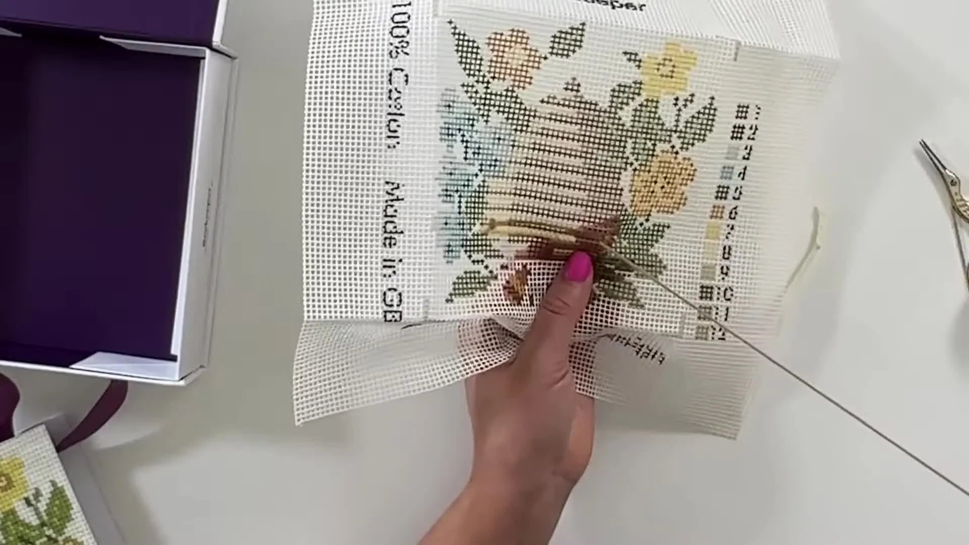 Completed light tan and partial medium brown sections on the needlepoint canvas.