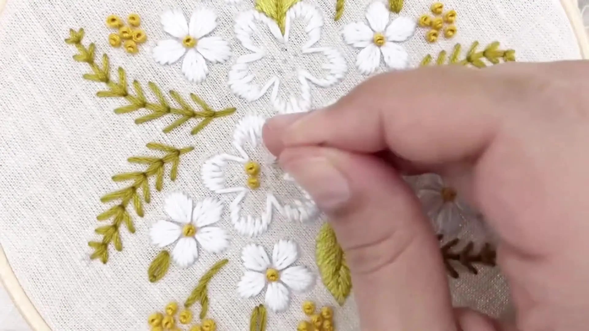 A completed flower with French knot center.