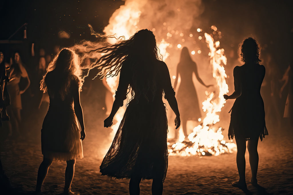 Women dancing around a huge bonfire