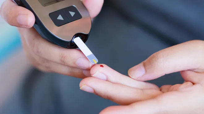 Person using a glucometer to check blood sugar levels.