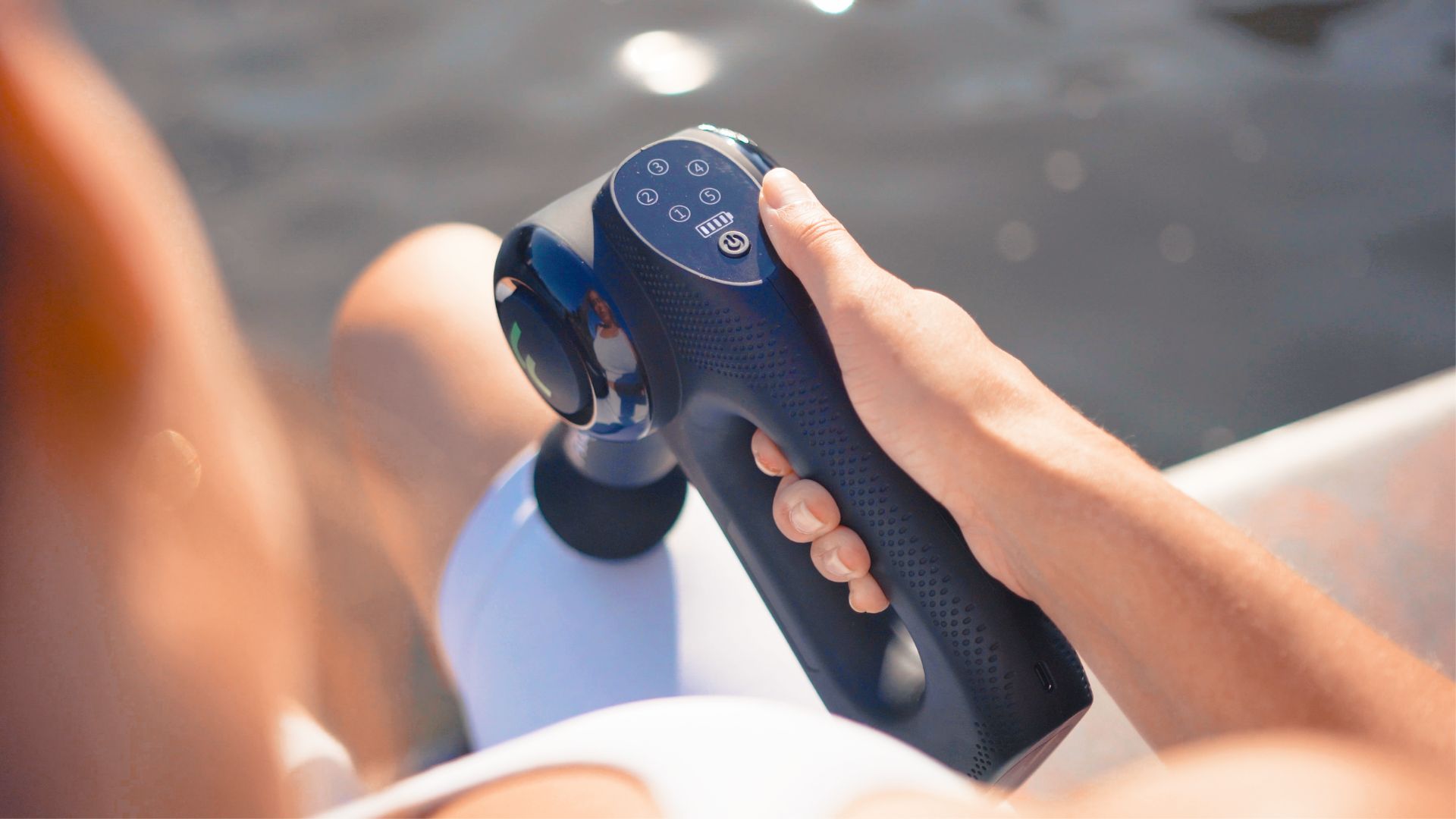 using a massage gun on your achilles