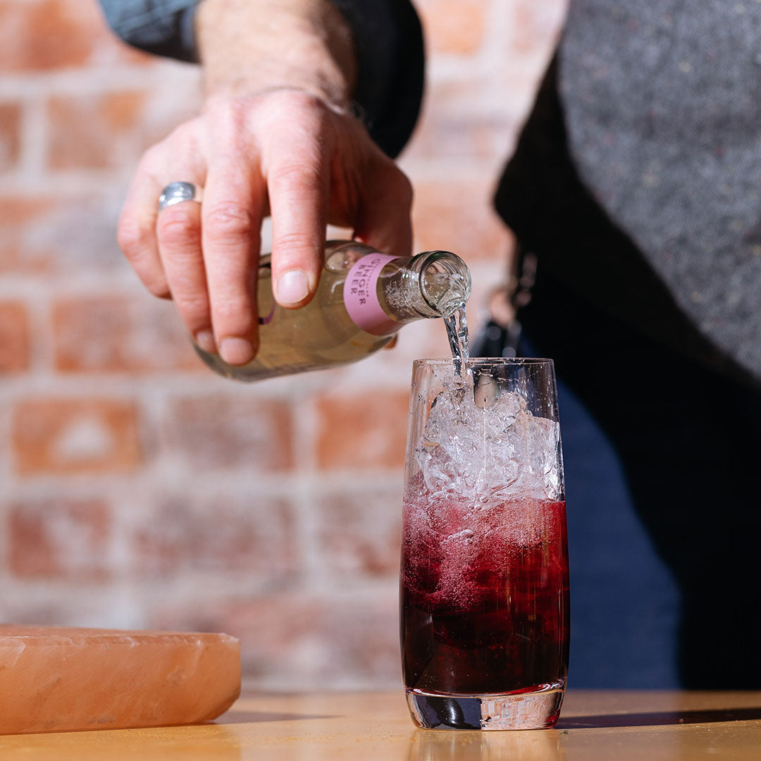 Pouring Ginger Beer in a Hibiscus Rum Buck