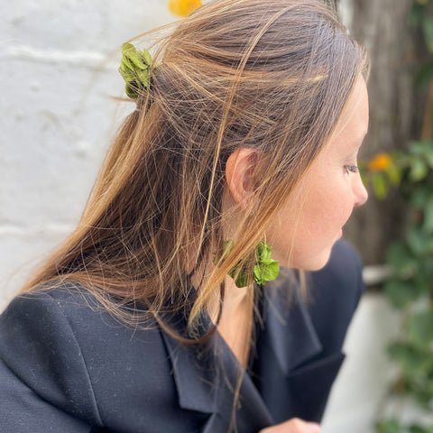 earrings with preserved flowers and matching dark green hairpins