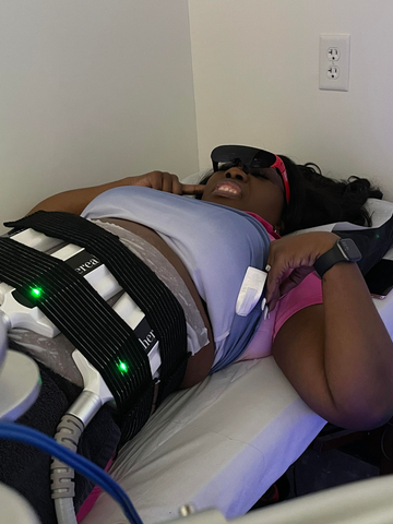 A woman lying on the bed using Rokid Air smart AI glasses
