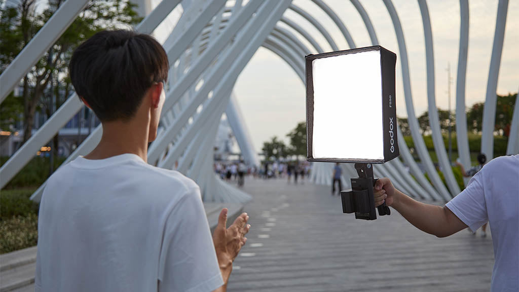 GODOX FH50Bi  with FS50 softbox being used to illuminate a person on a bridge.