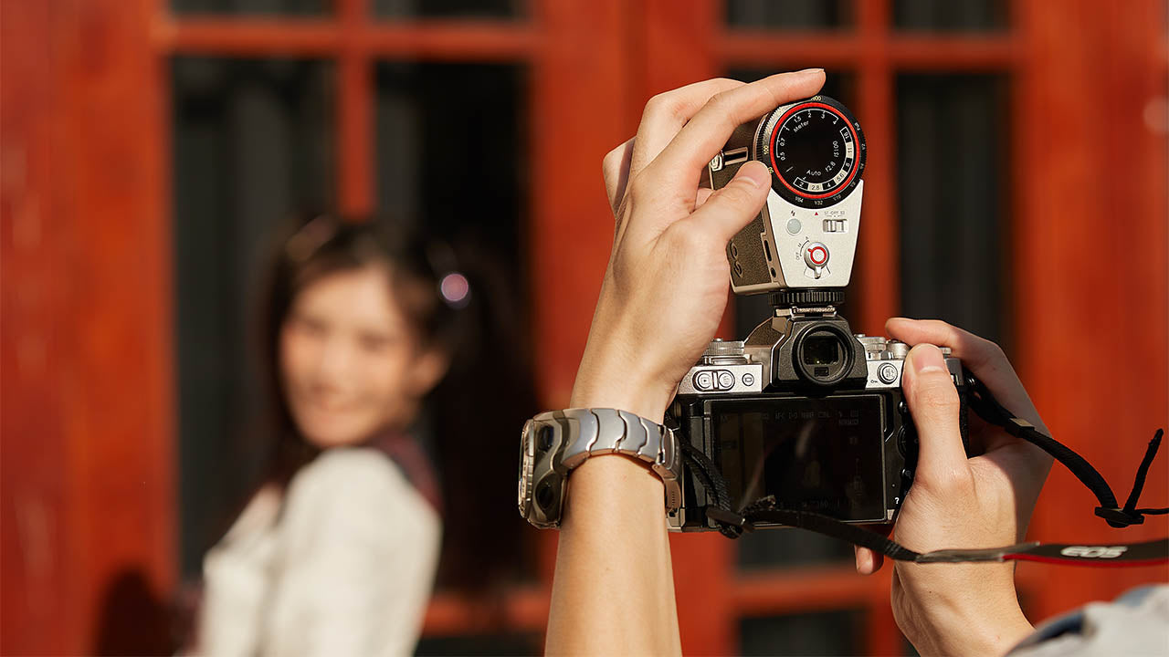 Person Photographing a girl using the Godox Lux Cadet in M Mode