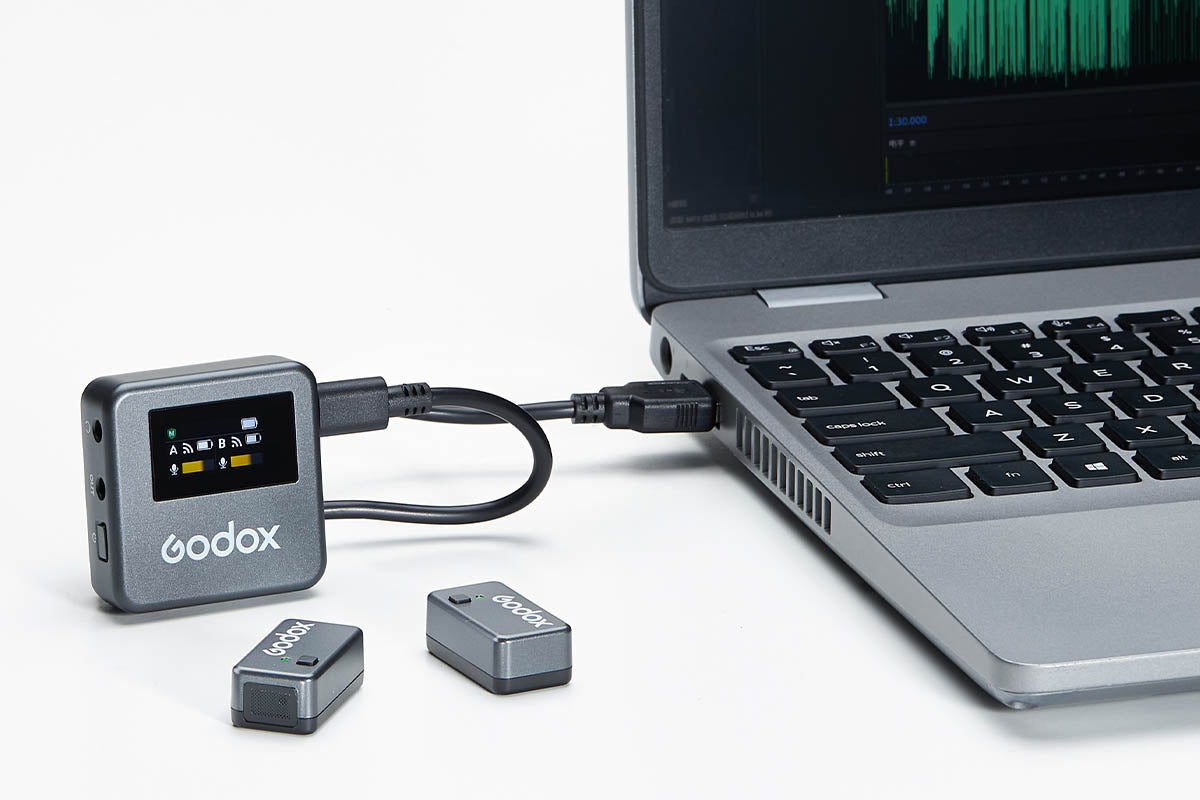 Godox Magic XT1 mic receiver being plugged into a laptop computer
