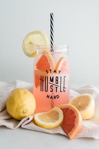 pink lemonade adorned with lemon and grapefruit slices in a 32 oz wide mouth reusable mason jar tumbler that reads stay humble, hustle hard