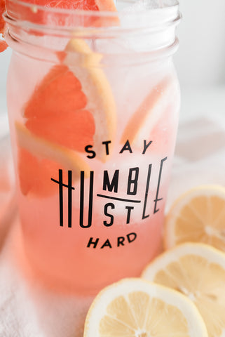 classic pink lemonade topped with fresh slices of grapefruit and lemon in a reusable mason jar tumbler