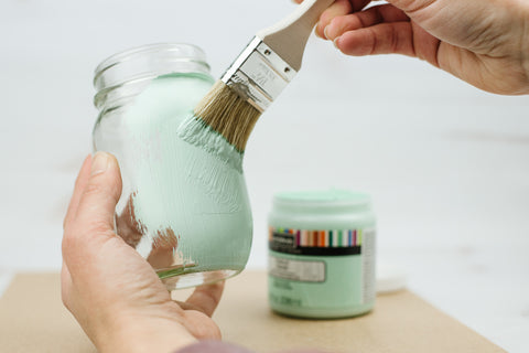painting a pint mason jar with light aqua chalk paint