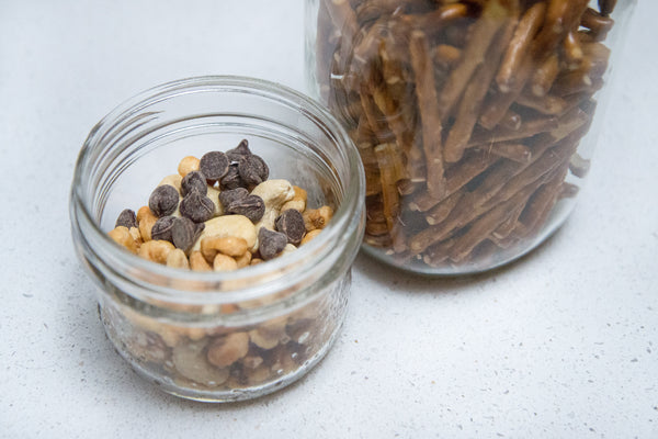 mason jar full of chocolate chips, pretzels and nuts