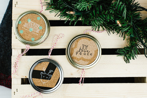 three DIY double-sided mason jar ring Christmas ornaments made from stamped cork
