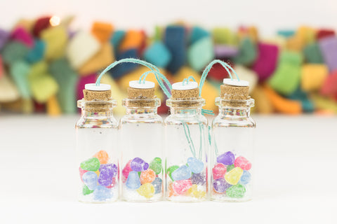 set of four handmade mini glass bottle ornaments filled with brightly colored gumdrops
